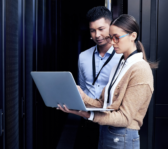 Two people working on a laptop computer.