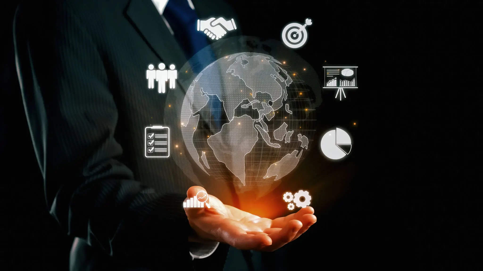 Businessman holding glowing digital globe with icons